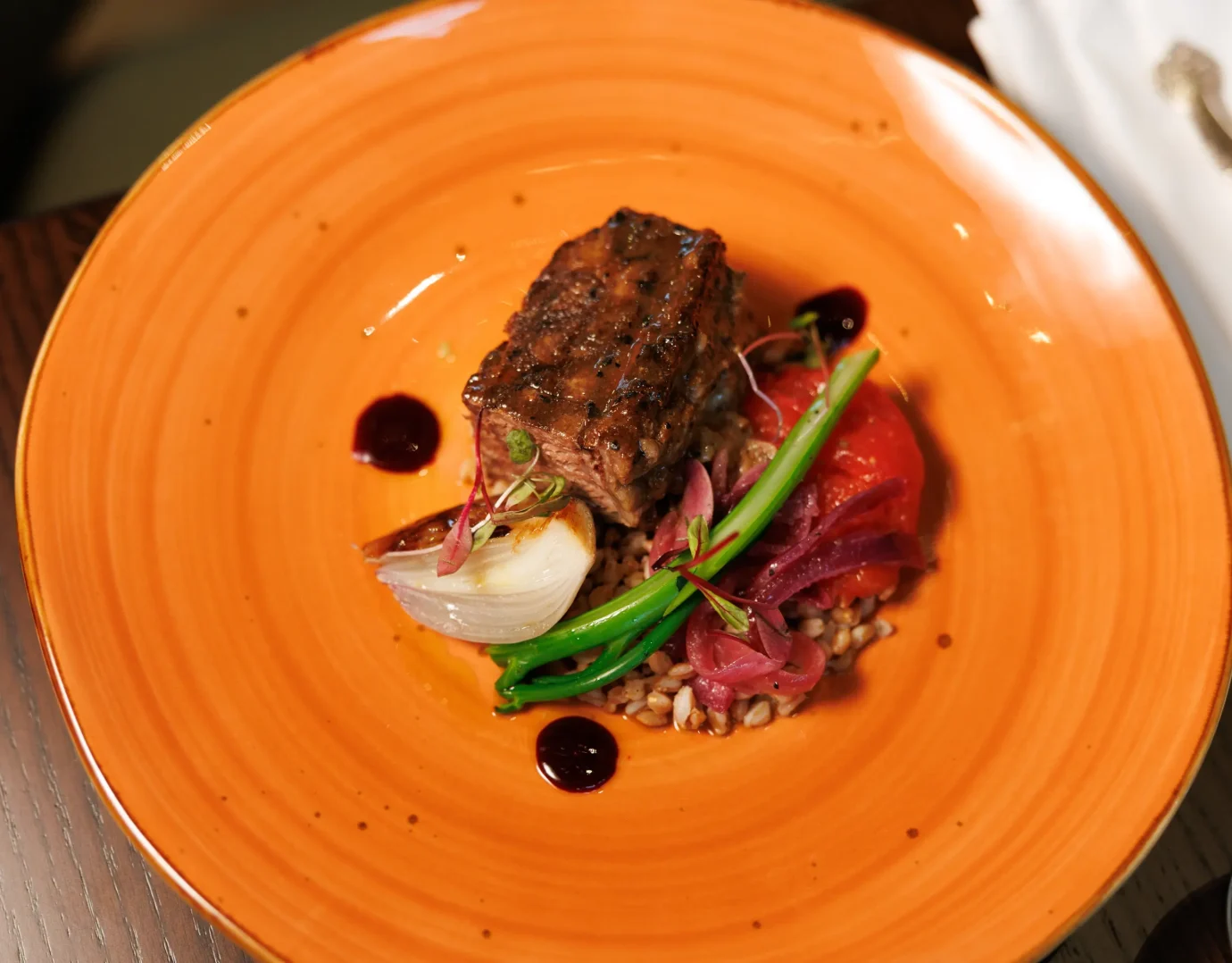 Main course served on an orange ceramic plate