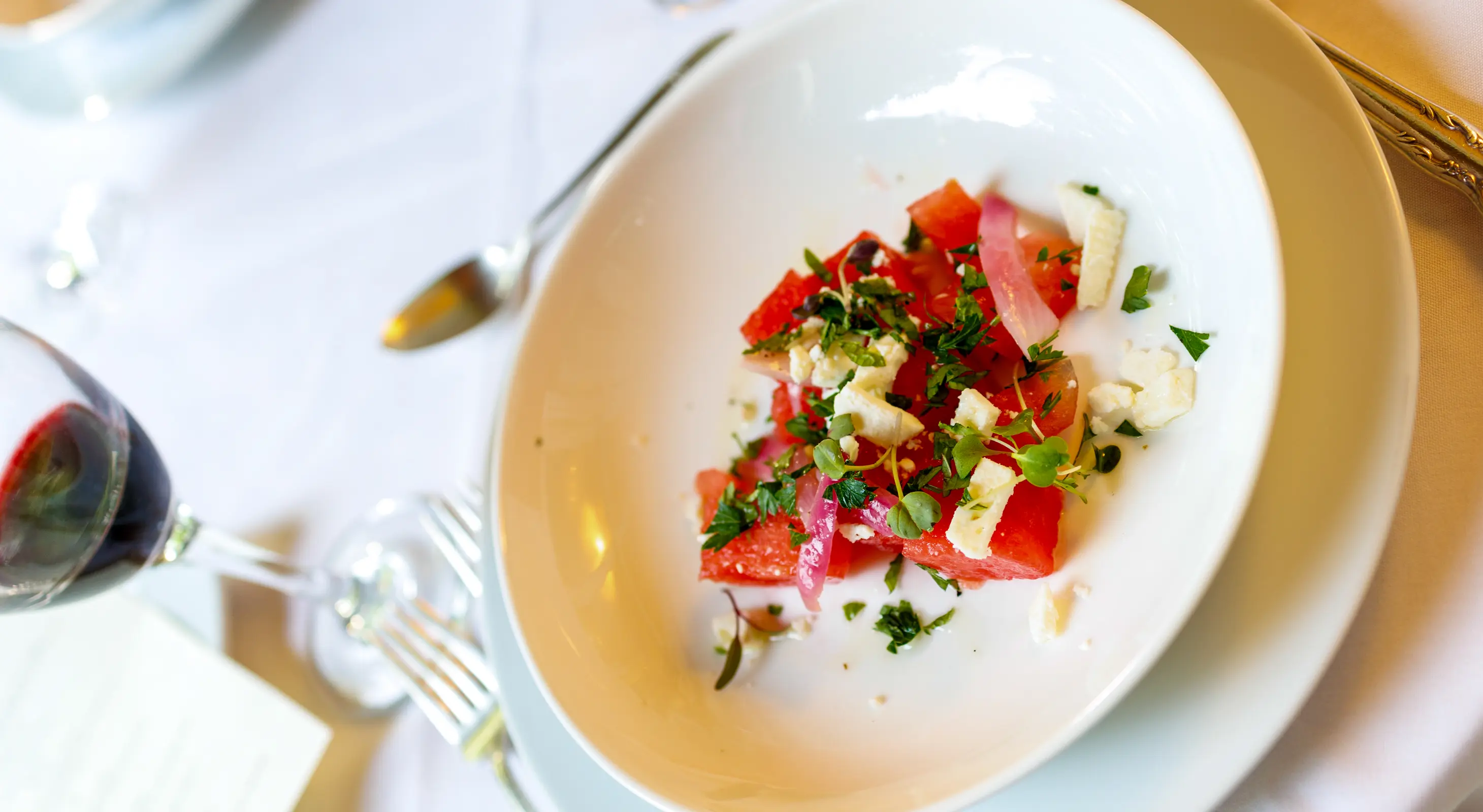 Salad course served in a white dish