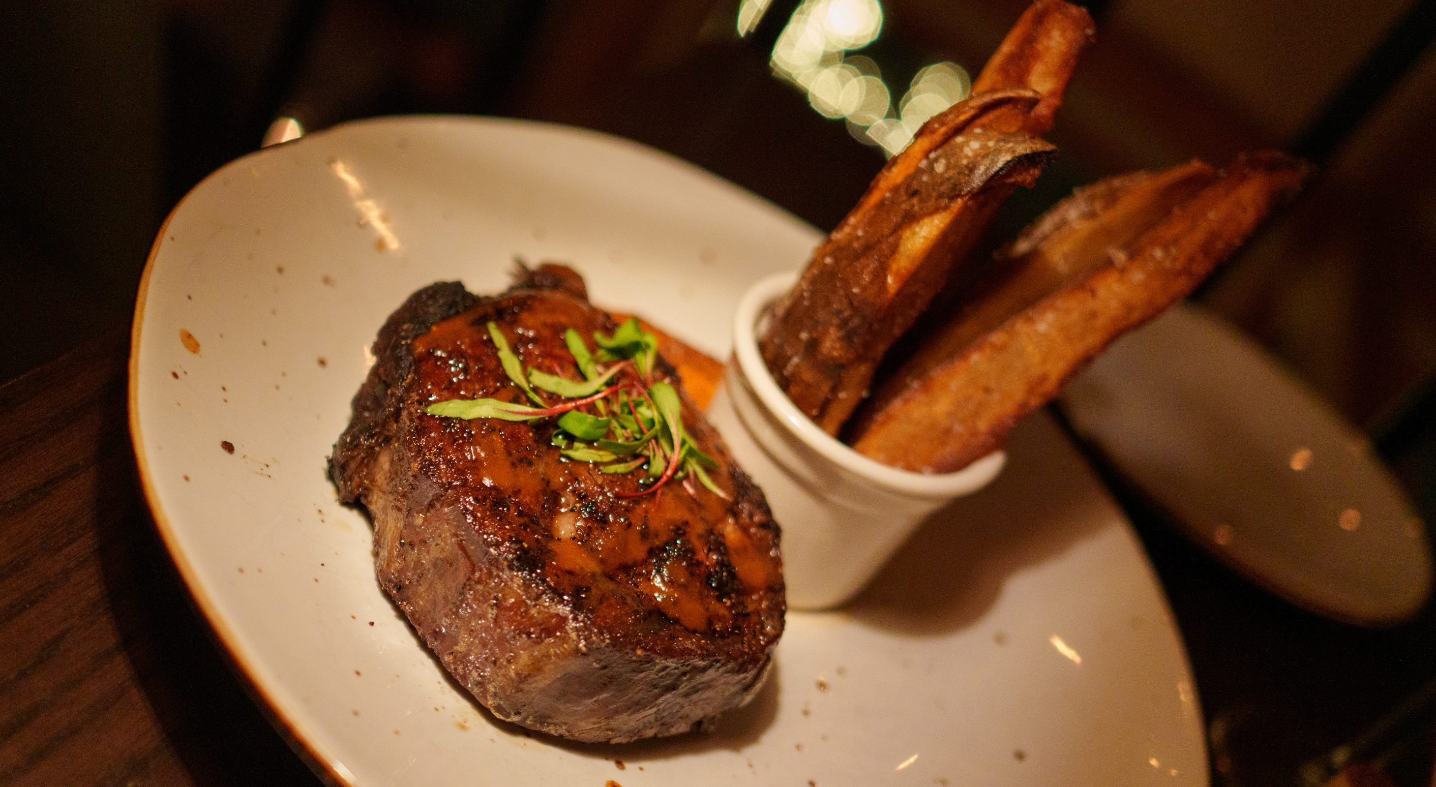 ribeye steak with French fries stacked vertically