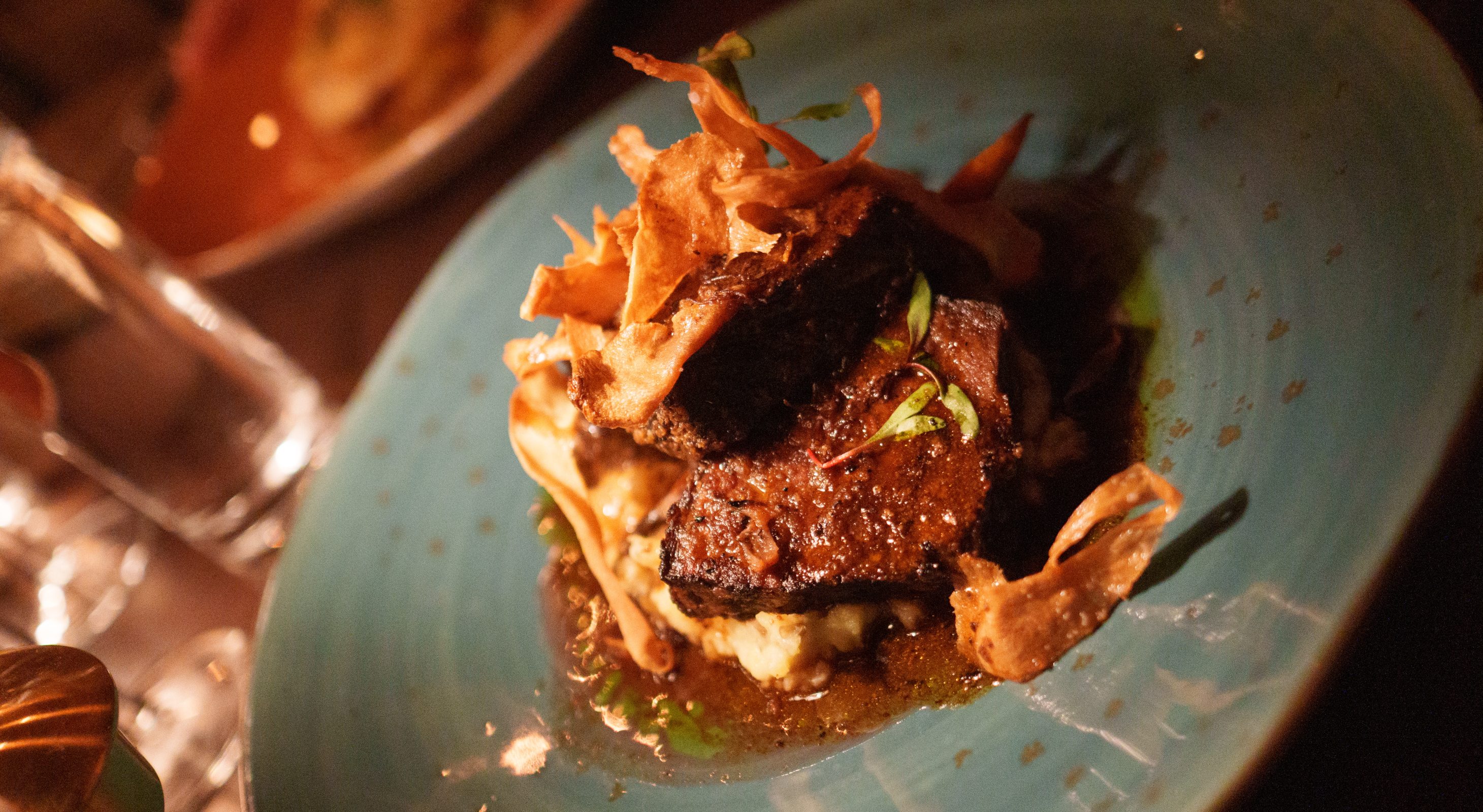 short ribs with crispy onions atop rice
